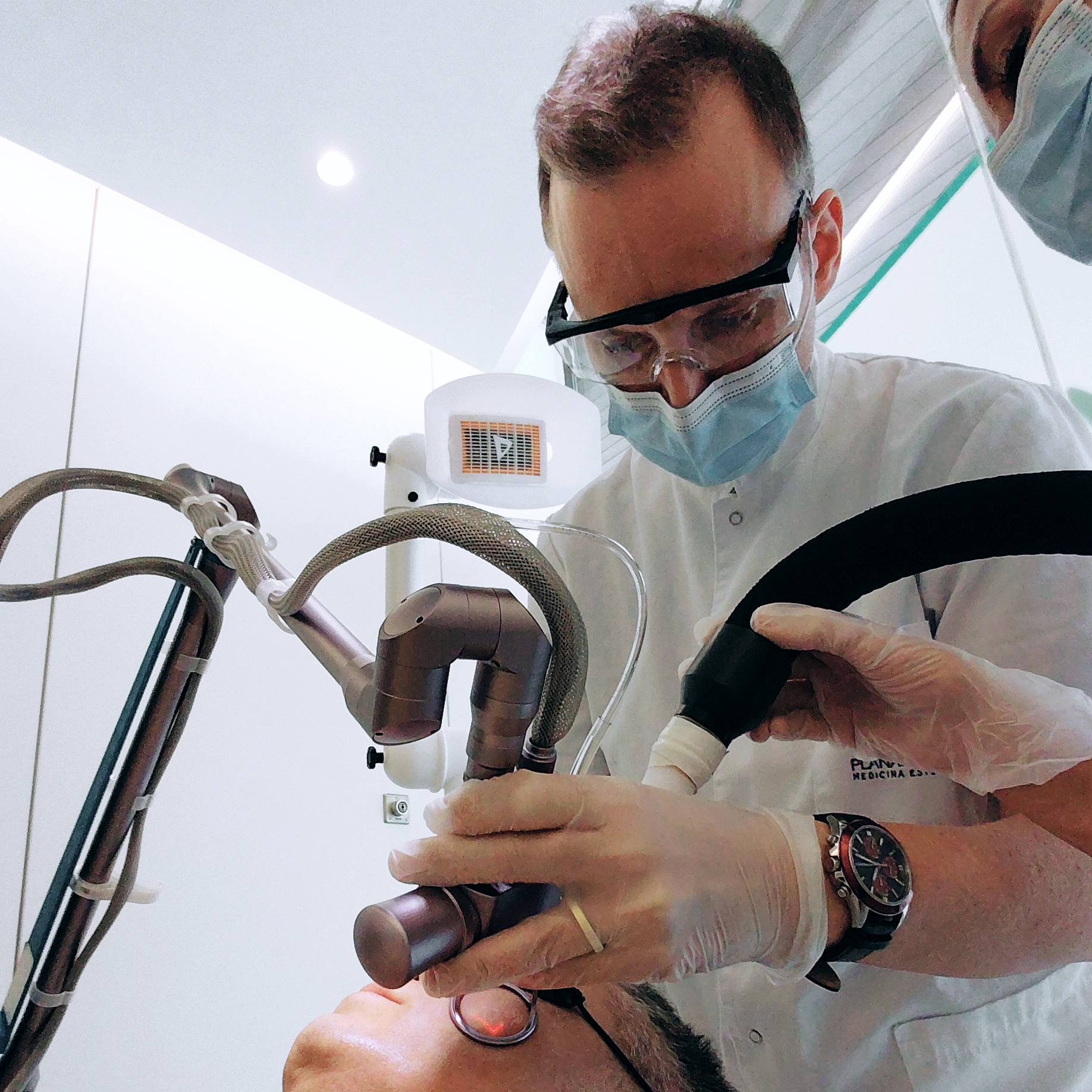 Dr Thomas Robertson performing laser treatment